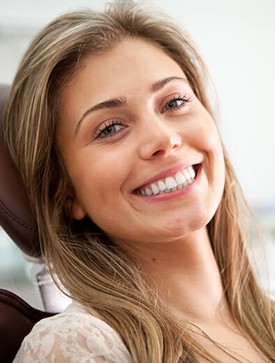 blonde woman sitting in a dental chair